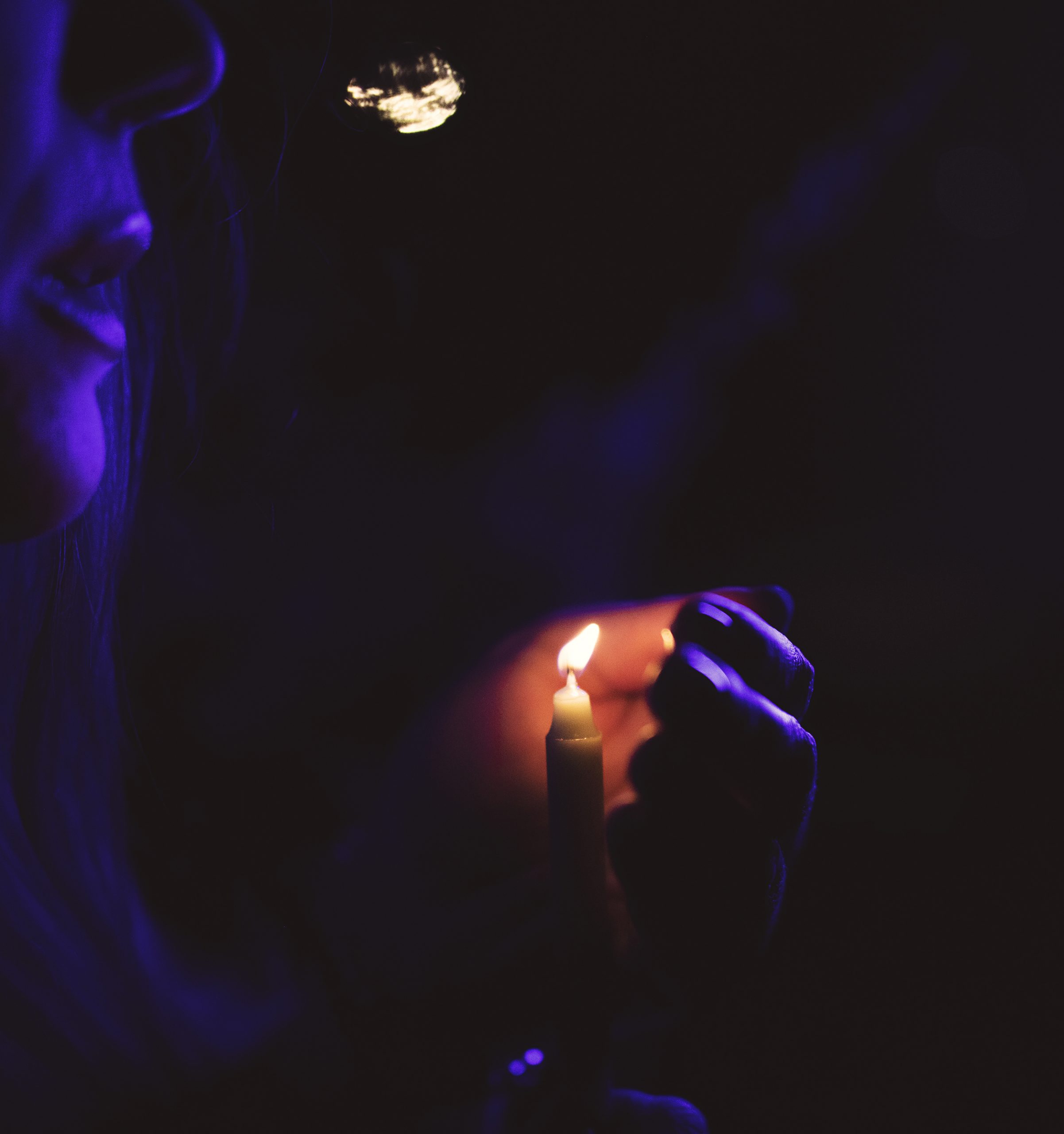 Sarah Martucci holding candle under moonlight